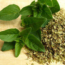 Load image into Gallery viewer, Fresh green and chopped, dried herb leaves of Oregano Origanum vulgare in a kitchen prior to cooking